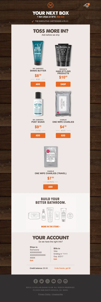 Dollar Shave Club recurring shipment reminder showing the customer’s next box and scheduled shipping date, with the current subscription item, add-on product recommendations that can be added before shipment, account and billing details, store links, and a referral credit offer.
